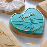 Friends forever crossing pinkies icing cookies