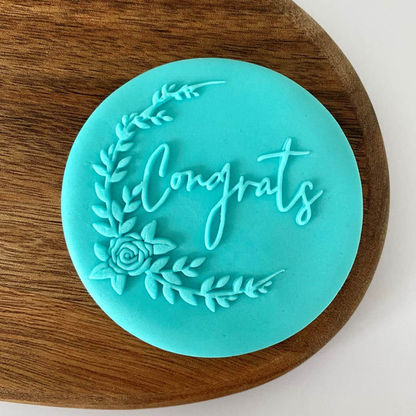Fondant cookie stamp with congrats message and flowers  on the left side