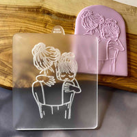 Mother and daughter reverse embosser cookie stamp. The debosser cutter is made from food safe frosted acrylic.